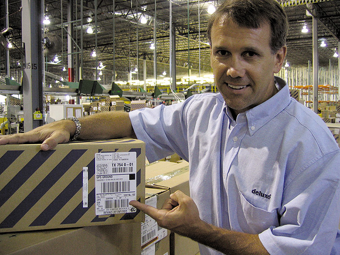 Little tag, big changes: Deluxe's director of engineering Jeff Nelson points to a small naked tag that RFID-enables a case of DV