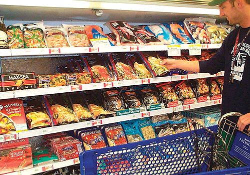 Private-label frozen fish fillets in stand-up pouches (right) were designed for Pathmark's newer upright freezer cases (above) w