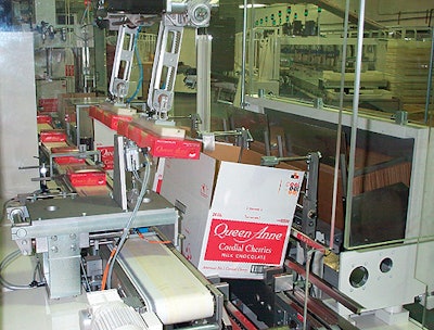 The cases are tilted for two-up loading (above) to keep the cartons forward so that a vertical divider can be inserted by the ro