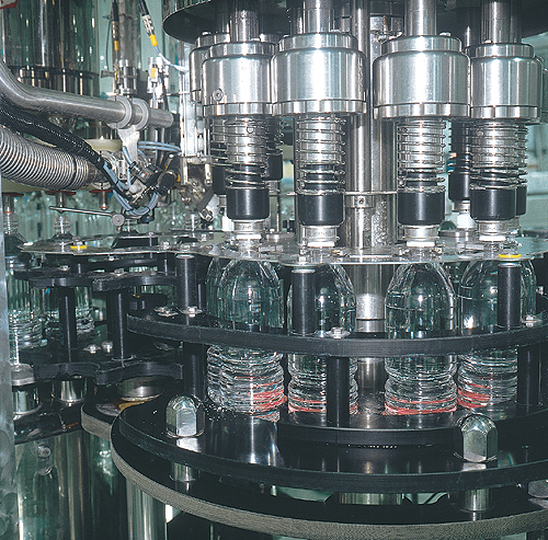 The 24-valve filler (above) is enclosed in a chamber where overpressured sterile air keeps contamination out.