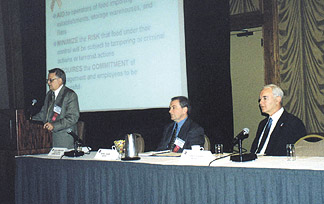Dr. David Armstrong of FDA addresses the conference, while Dr. Peter Slade (center) and Dr. Chuck Sizer look on.