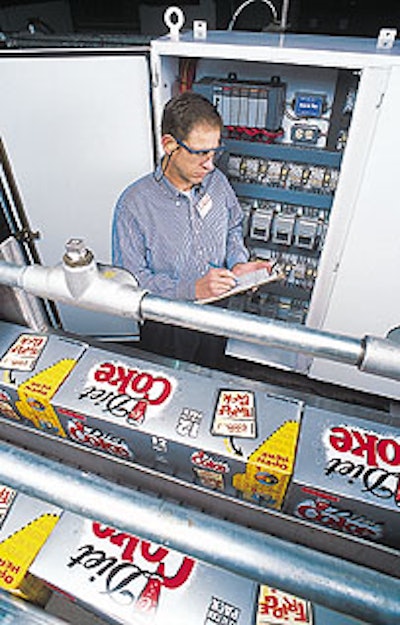 Kevin Colcord, project engineer checks the programming for the PLC that controls the conveyors.