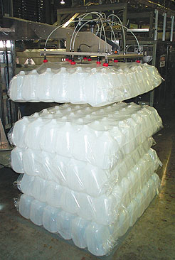 Lengthy line starts with robotic depalletizing where the bagged jugs are picked and placed onto an infeed table for automatic de