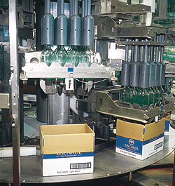 Bottles are removed from reshippers by a continuous-motion rotary-style uncaser (left).