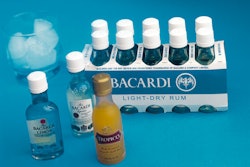 Ten 50-mL rum bottles are packed in an open-ended, neck-through paperboard carton to secure the bottles during case packing and