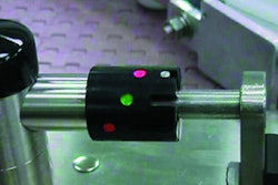 Guiderail adjustment assemblies include cylindrical components (shown above and inset) that display color dots that correspond t