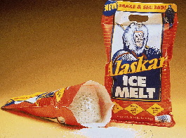 By holding a die-cut handle at the top and shaking the bag, users can dispense ice melting compound through a mesh bottom gusset