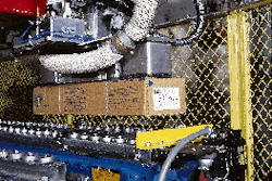 The robot?s gripper head picks up a case (above) after its bar-code label has been scanned. The scanned information is used to i