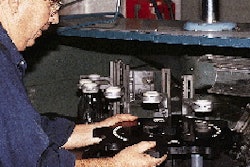 This close-up shows the starwheels and center guide for an air cleaner at Seagram?s LaSalle plant. Located on the center guide i