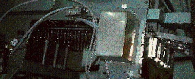Preforms are transferred by their necks (above) in four lanes towards a heating oven