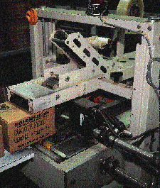 Mounted on the top-and-bottom taper is an ink-jet coder that prints name of product, expiration date, and lot code on one side