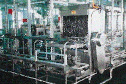 Once the 5-gal jugs have been sanitized, they are automatically conveyed around a corner and into the filling chamber (left). Wi