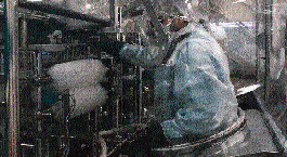 Here an operator has entered the intervention suit to make an adjustment in the area of the filler. The suit makes such adjustme