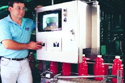 Steve Daniels checks the vision system as filled and capped bottles index to a downstream cooler