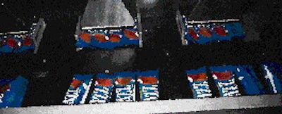Bars discharge from the wrapper six at a time, with three continuing on one right-angled conveyor (above), three on another. Aft