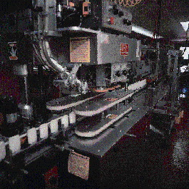 After discharging from the liquid nitrogen chiller, deodorant containers index to this capper for application of polypropylene c