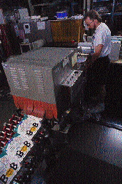 When the package emerges from the shrink tunnel, the clear glossy film is wrapped tightly around the box to provide a barrier to