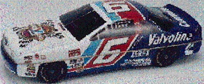 The two-piece tin (top) looks like a scale model of the race car. Even the bottom (above) is printed and formed to look like the