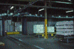 Two full pallet discharge stations are shown here, and immediately in front of them is the grooved track that guides the automat