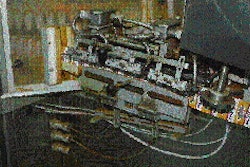 Pouches exit the rotary filling turret and are drawn through a top-sealing device