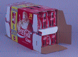 At left, an operator makes an adjustment at the control panel of Coca-Cola France?s new ?twin-stack? cartoner. A promotional