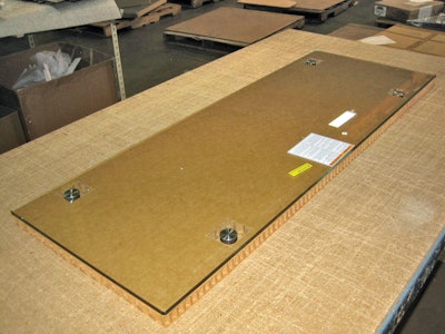 1. Glass panel is placed on 1-in. piece of honeycomb, cut slightly larger than the glass.