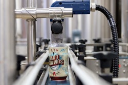 INK-JET CODING. Cans are inverted on a twist rail so that an ink-jet date code can be imprinted on the bottoms.