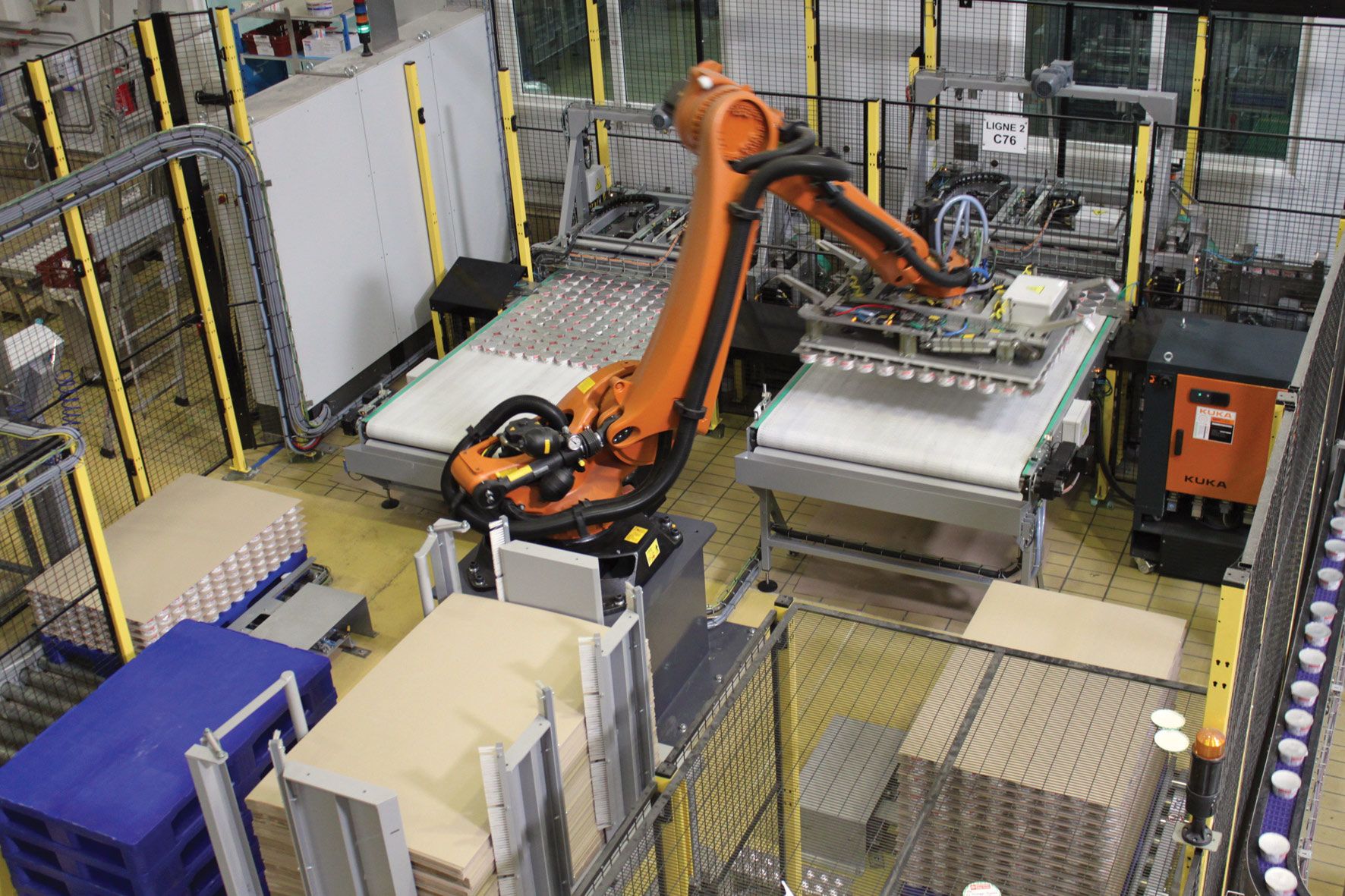 The robot handles output from two filling lines at a maximum speed of 96/hr. Tubs are gently handled with vacuum grippers as they are transferred to a trolley bound for a cooling room.