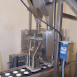 Honeyville uses a dual drop volumetric cup filler with staging gate to fill two containers at a time.