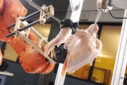 A robotic system used in the Intelligent Cutting and Deboning project prepares to slice through the shoulder joint of a chicken. (GT Photo: Gary Meek)