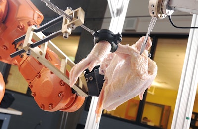 A robotic system used in the Intelligent Cutting and Deboning project prepares to slice through the shoulder joint of a chicken. (GT Photo: Gary Meek)