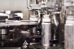 Liquid nitrous oxide is injected into a filled can via the chimney-like valve on the bottom of the can.