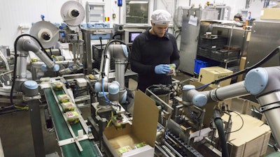 Atria employs three six-axis collaborative robots to automate tasks such as labeling, carton erecting, and palletizing.