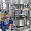 Located just ahead of the cleaner/filler/capper block on Line B, this pressure-sensitive labeler applies front, back, and neck labels if required.