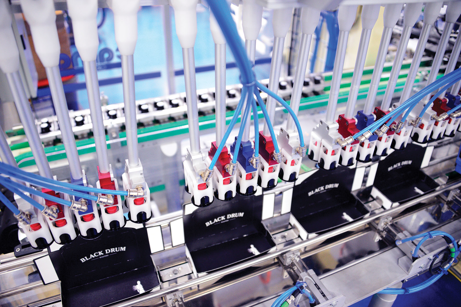 Four robotic end effectors on the cartoner efficiently place finished capsules into waiting cartons.