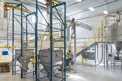 Side-by-side beam-and-hoist-style bulk bag dischargers allow for one frame to discharge peanuts while the other is reloaded. Photo courtesy of Flexicon Corporation.