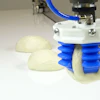 The dough production line employs four robots and relies on 3-D vision sensing at the start of the conveyor system to aid the robotic pick- and placing- of various pizza dough sizes.