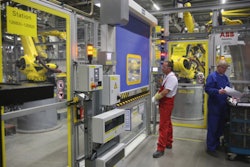 The image from a Porsche factory captures the ability of fewer workers to manage the tasks once handled by several employees.