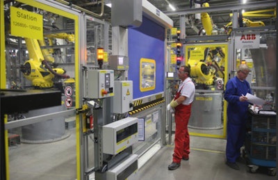 The image from a Porsche factory captures the ability of fewer workers to manage the tasks once handled by several employees.