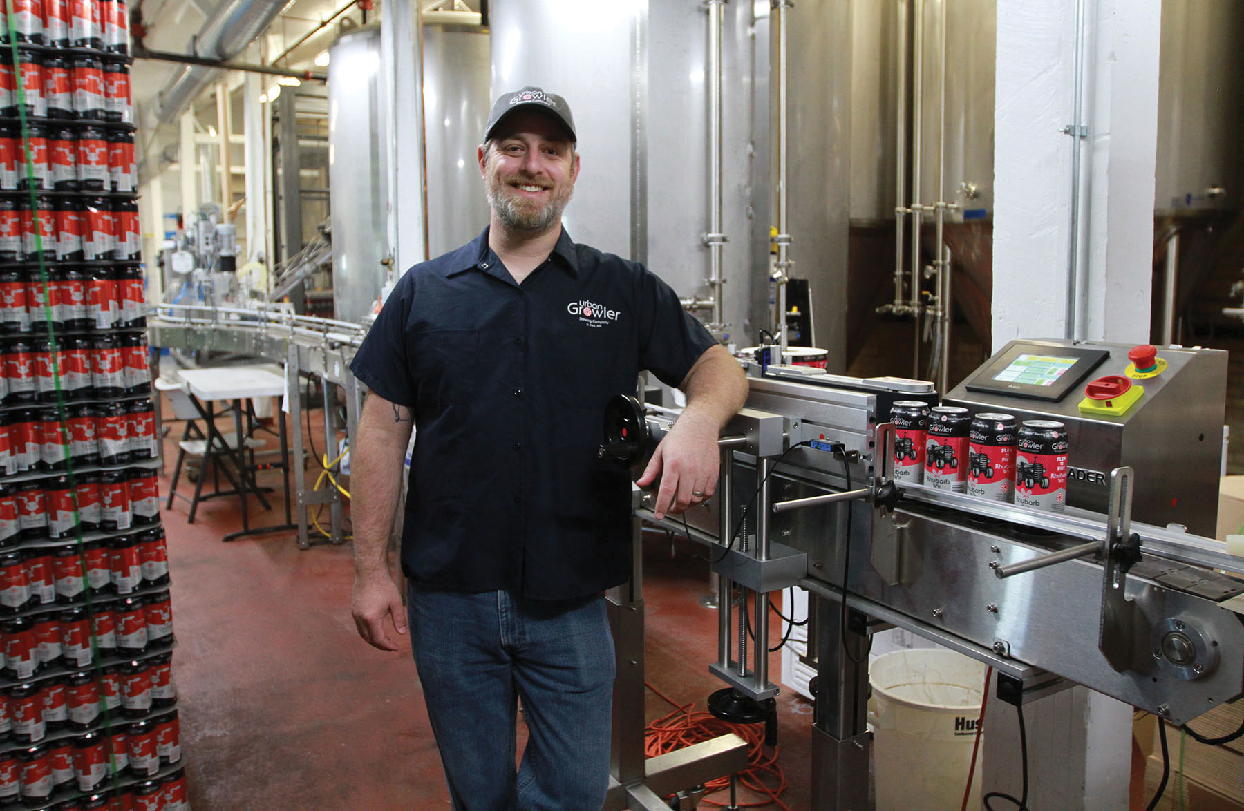 Jesse Pittman, head brewer, uses an in-line labeler to overwrap printed cans for small-batch runs requiring labels. When using higher volume printed cans that don&rsquo;t require labels, the filled cans pass through the machine unaffected.