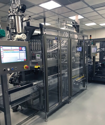 Two of these stick pack fillers sit at the head of the line. Visible on the far right is the robotic transfer unit that takes filled stick packs out of their shuttles and sends them through a 90-deg turn toward the cartoner.