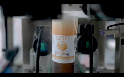 A shrink sleeve label is applied to the amber “stubby” bottle used by Flybeverage’s Nectr THC-infused seltzers.