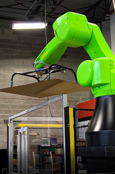 When a complete pallet stack arrives at one of the loading stations, the robot picks the cap sheet and places it on top of the stack.