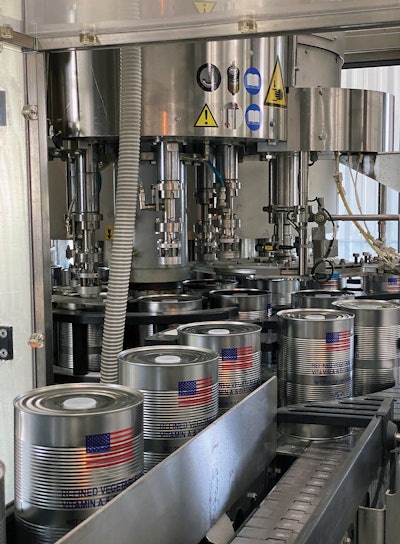 Filled and plugged, the 4-L cans exit the filler/plugger block and are conveyed to a wraparound case packer.