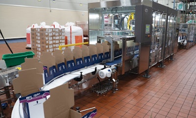 Shown here are freshly erected Cabrio Cases entering the robotic case packer.