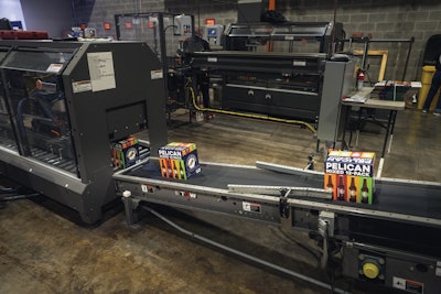 Cases run through a Pearson top sealer before palletizing, which initially was done by hand before the first TopTier palletizer was introduced.