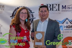 Emma Cole, a member of the Batavia Environmental Commission, presents Green Ole Award to Hector Leon, director of operations for GreenSeed Contract Packaging.