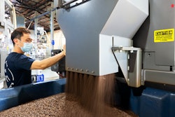 In this rotary batch mixer at Pablo & Rusty’s Coffee Roasters, internal flights direct beans toward and through a stationary discharge as the vessel rotates until fully evacuated.