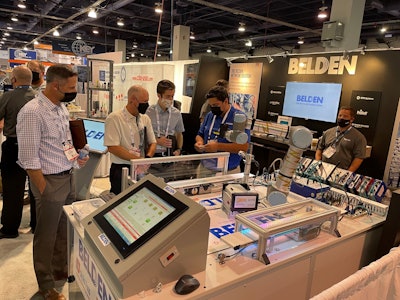 Costa Aralis demonstrating the robot application in the Belden booth at PACK EXPO Las Vegas 2021.