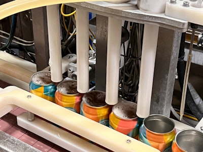 The cans run through two separate Wild Goose WGC 250 canning lines, where cans are rinsed and sanitized by two twist rinsers, filled, and seamed.
